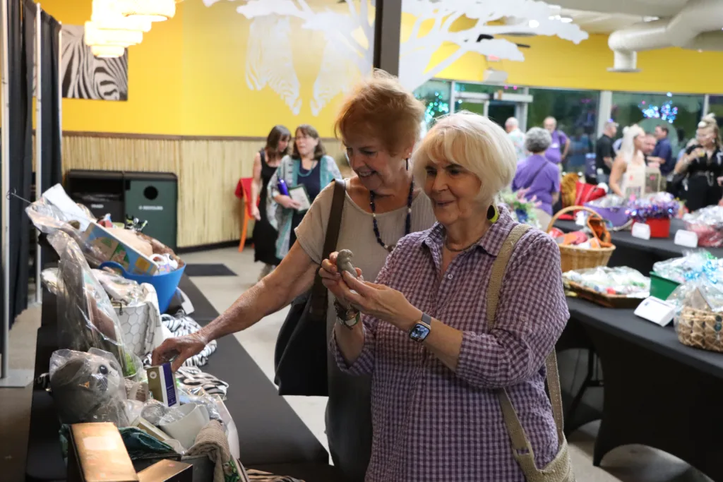Silent auction guests holding item